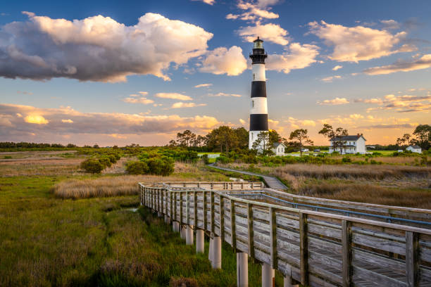 The Bodie Island Light Station in the Outer Banks of North Carolina, USA The Bodie Island Light Station in the Outer Banks of North Carolina, USA at dusk. headland stock pictures, royalty-free photos & images