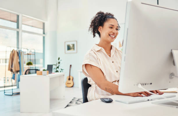 istock Computer, fashion and design with a creative woman at work in her office for modern or artistic style. Smile, workshop and technology with a happy young designer working in a studio for creativity 1663523743