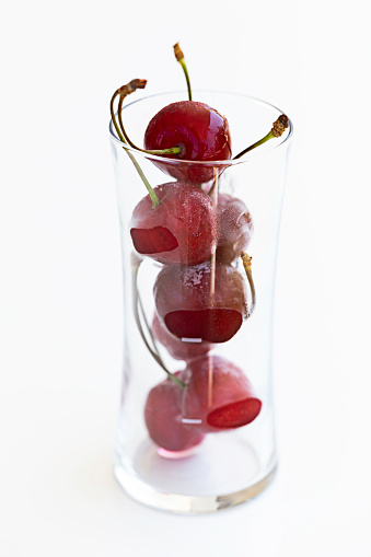 Cherry smoothies with fresh cherries on a wooden table. Delicious diet healthy drink, rustic style, selective focus