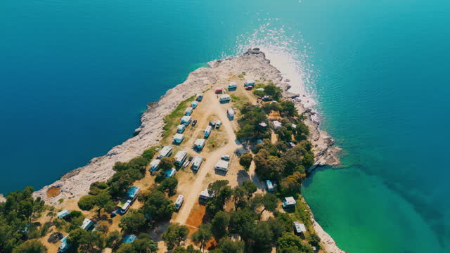DRONE Motorhomes parked on a camping ground near the shimmering blue sea
