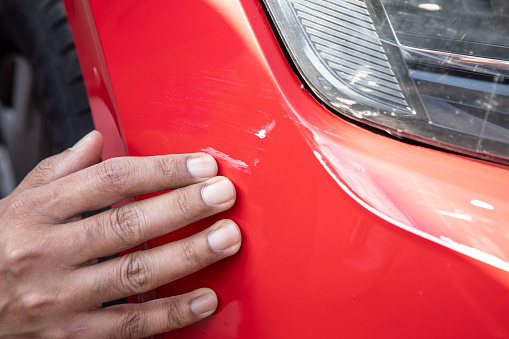 Examining damage to a car's bodywork for insurance purposes