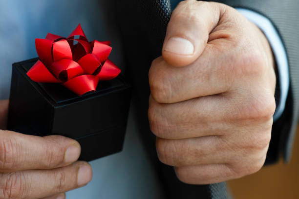 istock Businessman giving Gift Box 1663551657