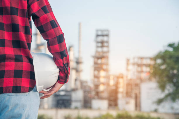istock Engineer woman hands holding hardhat white work helmet hard hat for Construction Engineering. Refinery woman engineer oil industry hands hold worker helmet hard hat. Refinery industry engineering 1663562378