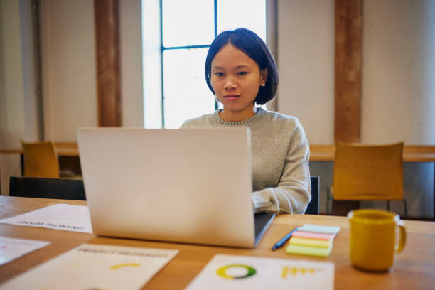 istock Businesswoman using laptop at office desk 1663562942