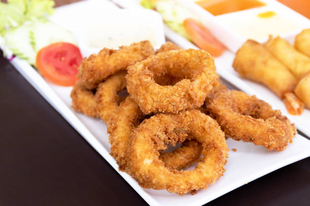 istock Salt and pepper squid deep-fried or Calamari on a white plate. 1663577824