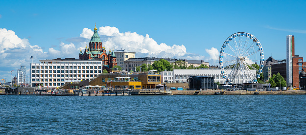 Cruise port of Helsinki. Panoramic view of city with cathedral, Ferris Wheel and buildings along the waterfront on a beautiful summer day.