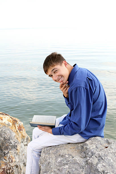 istock happy teenager with book 166358077