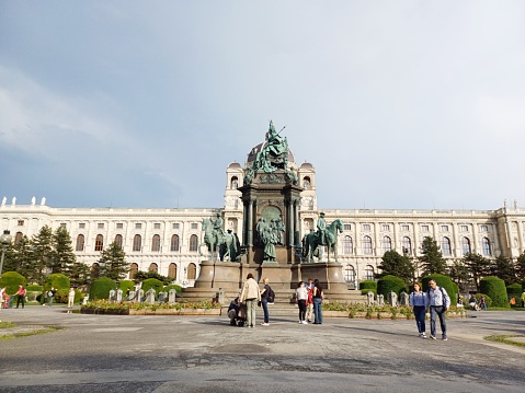 Vienna, Austria - June 7, 2023: Tourists visit and walk across Maria Theresa Memorial in Vienna, Austria in a summer day.