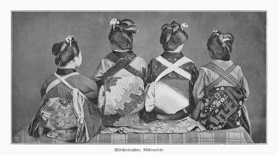 Japanese girls in traditional dress - back view. Nostalgic scene from the past. Halftone print after a photograph, published in 1900.