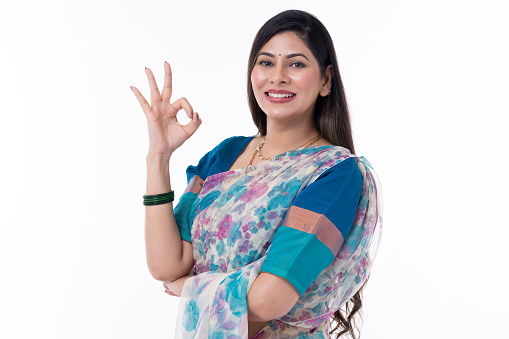 Beautiful Indian woman showing okay hand sign on white background