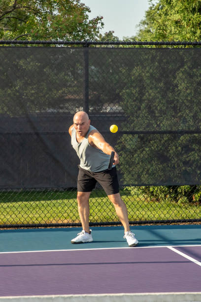 istock Male Pickleball Player Returns Serve with his Backhand 1663615353