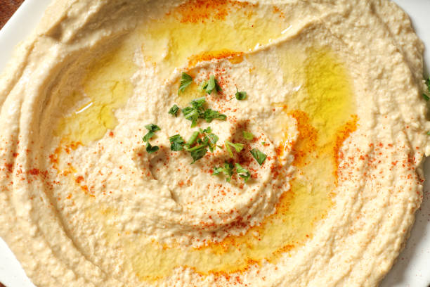 Healthy Homemade Creamy Hummus with Olive Oil Close up Hummus plate hummus stock pictures, royalty-free photos & images