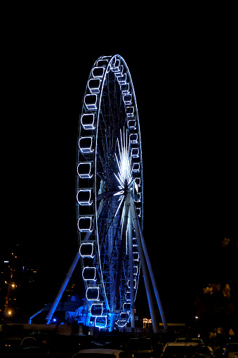 London, United Kingdom - October 16, 2013: London Eye spinning in the evening with reflection in the Thames