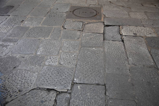 detail of a street made of different types of bricks and stones in the downtown area of medieval fortress city of Calcata, Italy