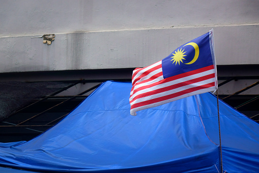 The flag of Malaysia is composed of a field of 14 alternating red and white stripes along the fly and a blue canton bearing a crescent and a 14-point star known as the Bintang Persekutuan (Federal Star). The 14 stripes, of equal width, represent the equal status in the federation of the 13 member states and the federal territories, while the 14 points of the star represent the unity between these entities. The crescent represents Islam, the country's state religion; the blue canton symbolises the unity of the Malaysian people; the yellow of the star and crescent is the royal colour of the Malay rulers.