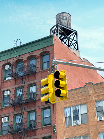 Detail from a New York street with buildings, traffic lights with old water tank