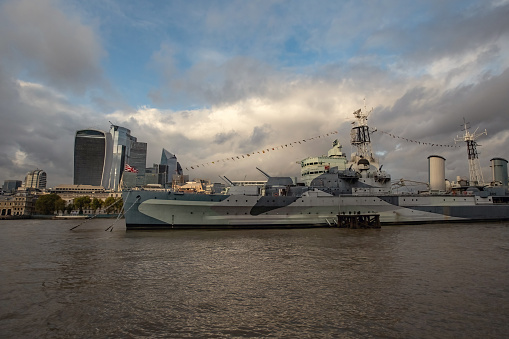 Military ship on thames river in london UK