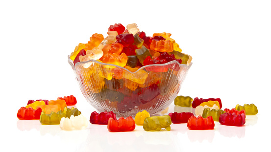 SONY DSCColorful fruity gummy bears in a small glass bowl, in front of a white background