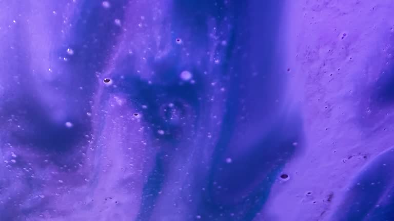 Colorful soap suds rinsing off car windshield form textured background