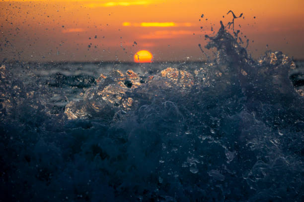 istock A wave crashing at sunrise on the sea 1663657836