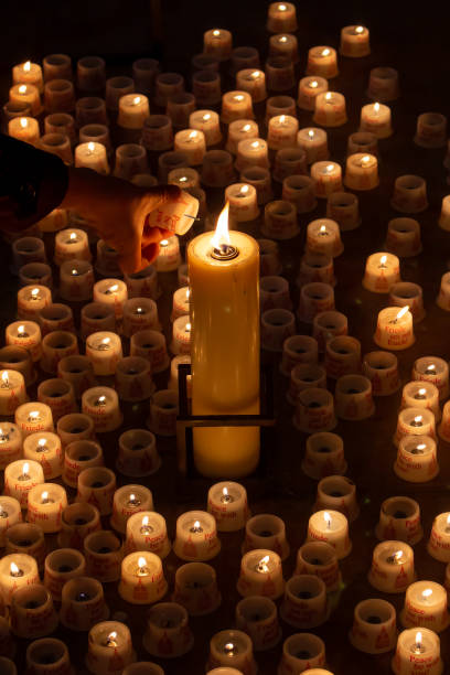 istock A hand lights a candle in a church 1663658923