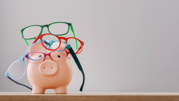 istock Cute piggy bank choosing new eyewear 1663683837
