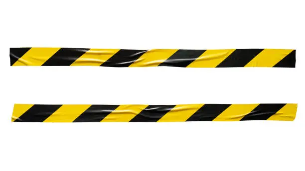 Yellow and black barricade tape on white background with clipping path