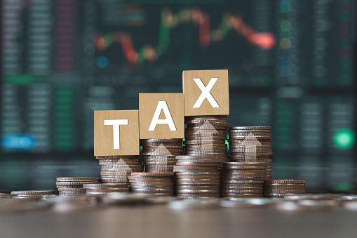 Tax concept of interest rate and dividends Calculation of income and return on investment as a percentage of the stock market. Close-up view of charts throughout stocks on background