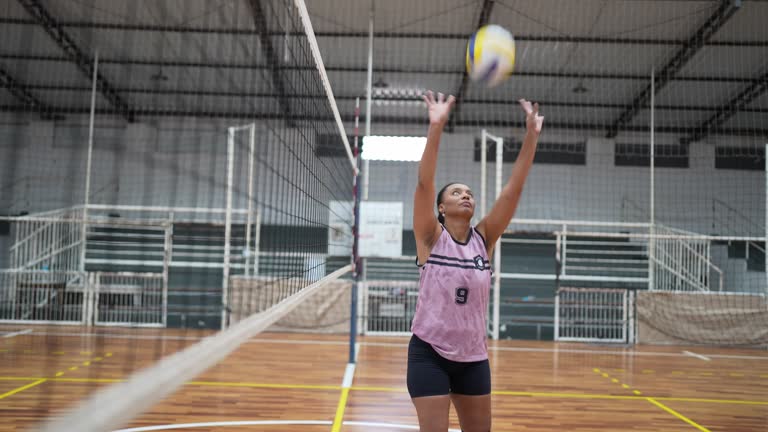 Female volleyball team warming up before the match on the sports court