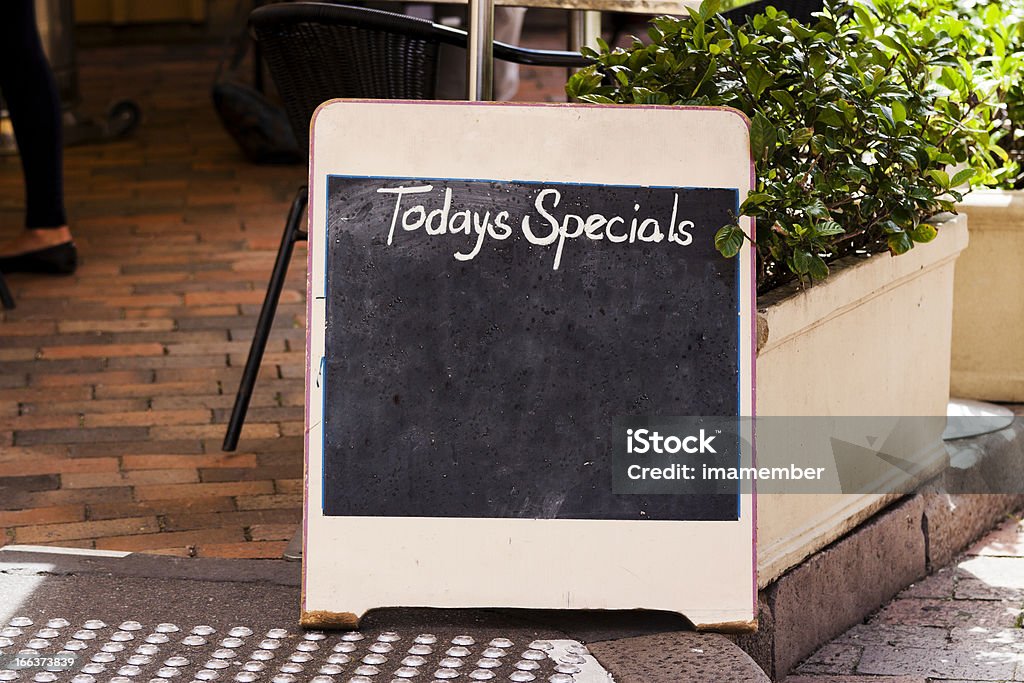 Restaurant blackboard sign "Todays Specials" on footpath, copy space Blackboard sign "Todays Specials" with empty space front of the restaurant on footpath, full frame horizontal composition with copy space Chalkboard - Visual Aid Stock Photo