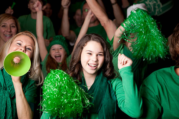 istock Sports Fans: Adults Children Cheering Spectators Event Team Color Green 166374230