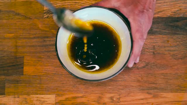 Close up of Olive Oil and Balsamic Stirred in slow-motion by Italian chef