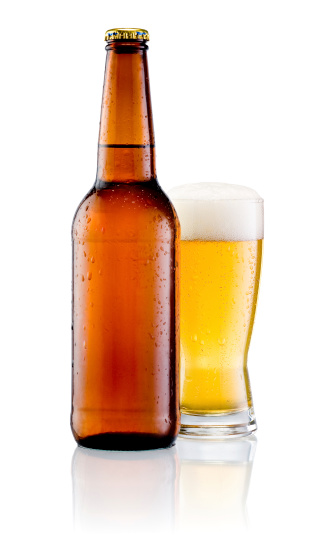 Brown bottle with drops and Glass of beer isolated on a white background