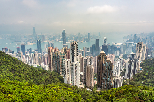 Hong Kong,March 26,2019:Panorama of skyscrapers, victoria harbor and hong kong bay taken from victoria peak park on hong kong island during a hazy day