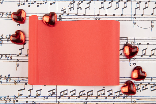 Hearts  and red paper on musical score