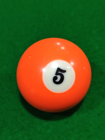 A billiard ball on the billiard table numbered 5