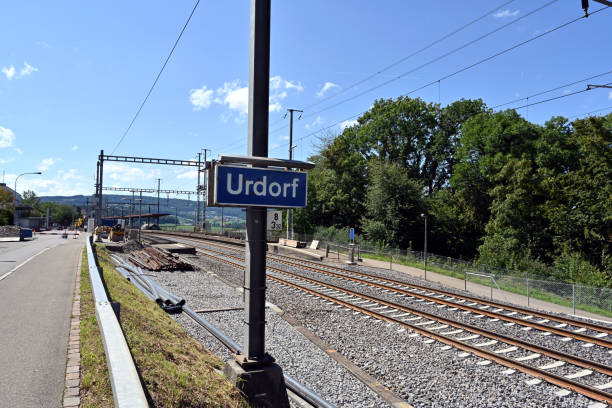 The tracks leading to the railway station in village Urdorf in Switzerland. The tracks leading to the railway station in village Urdorf in Switzerland. There are some spare rails and pipes aside during reconstruction of the track. railroad track concrete railway sleeper thoroughfare stock pictures, royalty-free photos & images