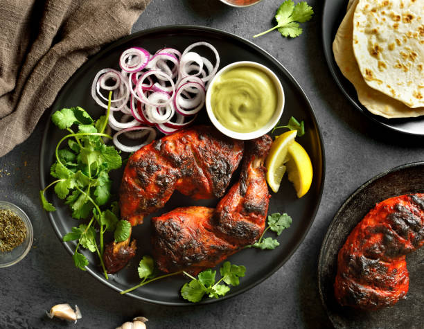 istock Tandoori chicken served with cilantro and onion 1663791090