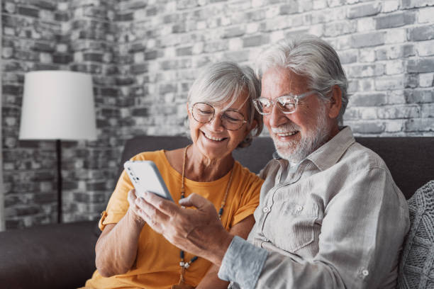 istock Elderly grandfather and grandmother spend time having fun using smartphone apps, middle-aged wife enjoy online entertainments, taking selfie with old husband, older generation and modern tech concept 1663799889