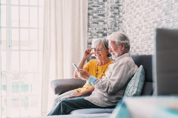 istock Elderly grandfather and grandmother spend time having fun using smartphone apps, middle-aged wife enjoy online entertainments, taking selfie with old husband, older generation and modern tech concept 1663802580
