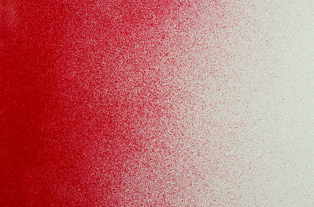 Red Sprayed Paint Background Bright red paint sprayed on a white background. Copy space on the red and white. spray paint stock pictures, royalty-free photos & images