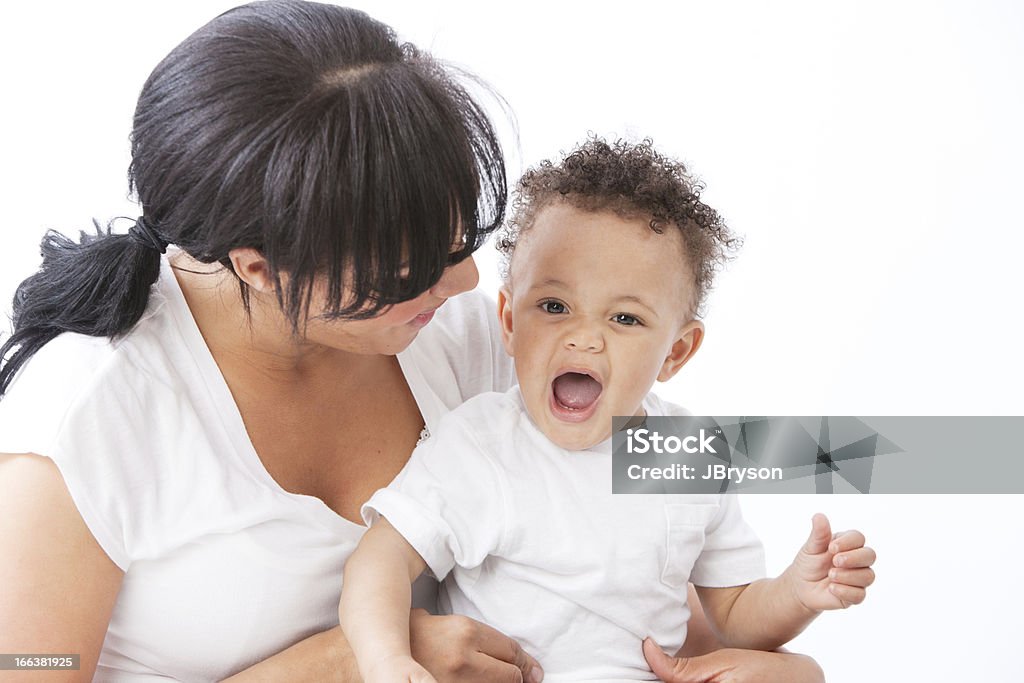 Real People: Black African American Mother Talking to Toddler Boy A head and shoulders image of a Black / African American mother holding and talking to her toddler little boy. Talking Stock Photo