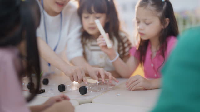Children learn about science experiments in the classroom at an international school activity joyfully and happily.