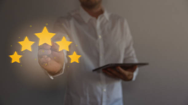 istock Review, increase rating or ranking, evaluation and classification concept. Businessman draw five yellow star to increase rating of his company. Bokeh in background. 1663833909