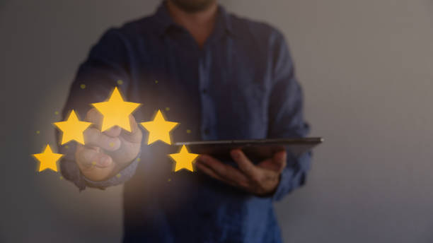 istock Review, increase rating or ranking, evaluation and classification concept. Businessman draw five yellow star to increase rating of his company. Bokeh in background. 1663834058