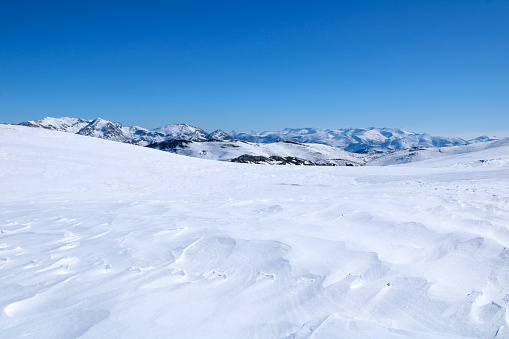 Snowy landscape of mountains with blue sky