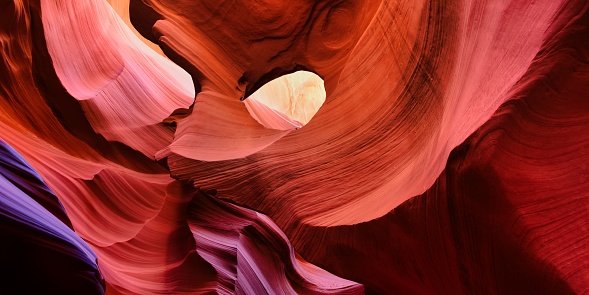 A breathtaking panoramic view of the majestic Antelope Canyon in Arizona, USA, with its striking red sandstone walls, winding pathways, and natural