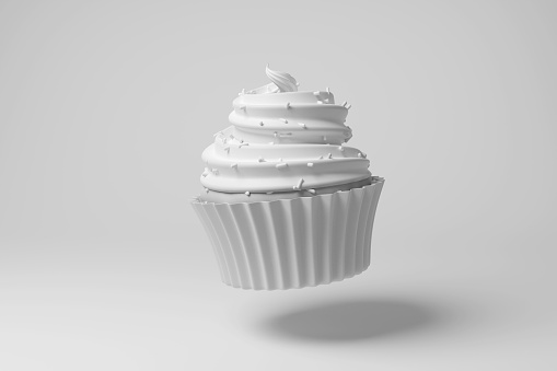 White cupcake floating in mid air on white background in monochrome and minimalism. Illustration of the concept of cookery, dessert and confectionery
