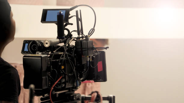 istock Behind the 4k high defination video camera shooting by film crew team in big studio production. 1663932234