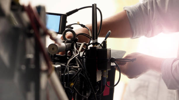 istock Behind the 4k high defination video camera shooting by film crew team in big studio production. 1663932235